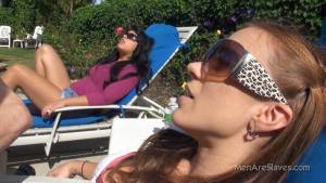 Two girls are relaxing in the sun enjoying masked sub giving massage to their fes7n6tuw3e1.jpg
